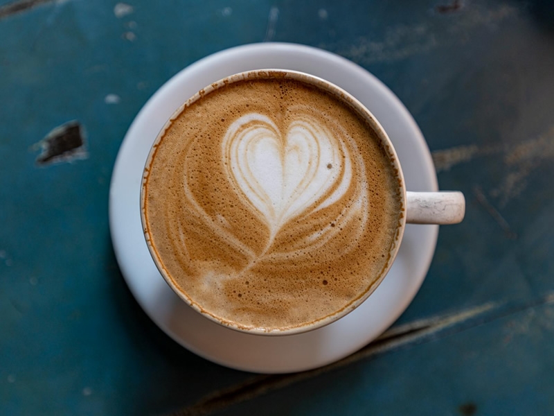 Cup of hot cocoa with a heart shape on top.